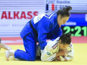 CORRECTS THAT SABINA GILIAZOVA IS ON TOP - Sabina Giliazova of Russia and Blandine Pont of France, bottom, in action during the women's -48 category at the World Judo Championships in Doha, Qatar, Sunday, April 5, 2023.