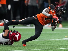 B.C. Lions' Lucky Whitehead, right, is tackled by Calgary Stampeders' Jonathan Moxey during the second half of CFL football game in Vancouver, on Saturday, September 24, 2022.