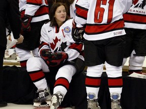 Team Canada captain Cassie Campbell sits on a bench at the team’s official photograph session in Halifax on March 29, 2004.