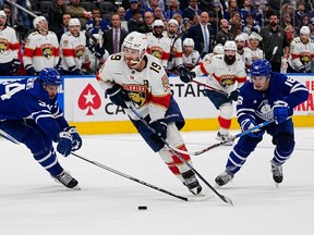 Florida Panthers forward Matthew Tkachuk (19) carries the puck past Toronto Maple Leafs defenseman Morgan Rielly (44) and forward Mitchell Marner (16) during the second period of game two of the second round of the 2023 Stanley Cup Playoffs at Scotiabank Arena.