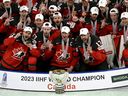 Canadian players celebrate winning the IIHF World Ice Hockey Championship 2023 with the trophy.