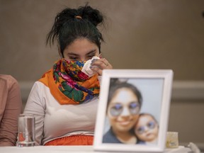 Kyla Frenchman, mother of Tanner Brass, wipes a tear at a joint media event organized by The Federation of Sovereign Indigenous Nations in Saskatoon, Wednesday, on March 2, 2022.
