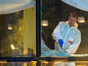 Workers clean the area around the scene of a shooting at Vancouver's Wall Centre restaurant in January 2012.