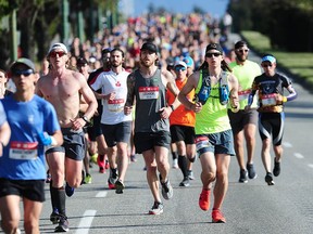 The front runners race along Cambie Street during the 2019 BMO Vancouver Marathon. Many roads will again be closed on a rolling basis during Sunday's event.