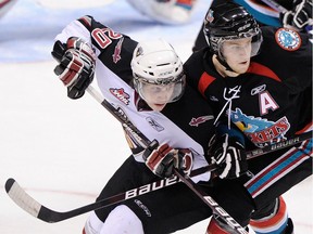 Vancouver Giants JT Barnett, left , collides with Kelowna Rockets Tyler Halliday during second period WHL regular season action at the Pacific Coliseum in Vancouver January 3, 2010.