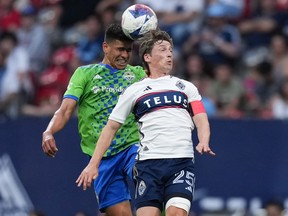 Seattle Sounders' Xavier Arreaga and Vancouver Whitecaps' Ryan Gauld