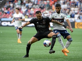 Houston Dynamo FC midfielder Artur (6) battles for the ball against Vancouver Whitecaps FC midfielder Pedro Vite (45) during the first half at BC Place.