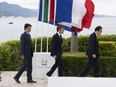 Prime Minister Justin Trudeau, left to right, follows French President Emmanuel Macron and Japanese Prime Minister Fumio Kishida as they take their places for a family photo at the G7 Summit, Saturday, May 20, 2023 in Hiroshima, Japan.