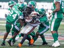The Saskatchewan Roughriders make a tackle on B.C. Lions running back Taquan Mizzell during pre-season CFL action at Mosaic Stadium on May 27 in Regina.