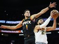 Phoenix Suns guard Devin Booker blocks the shot of Denver Nuggets guard Jamal Murray.