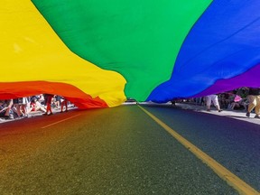 A rainbow flag is carried through the street during Vancouver's Pride Parade in 2022.