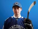 Quinn Hughes poses after being selected seventh overall by the Vancouver Canucks during the first round of the 2018 NHL Draft at American Airlines Center on June 22, 2018 in Dallas, Texas.