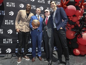 Toronto Raptors president Masai Ujiri (L) introduces their new head coach Darko Rajakovic with Larry Tanenbaum and general manager Bobby Webster (R) outside the Scotiabank Arena in Toronto on June 13, 2023.