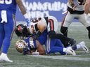 Winnipeg Blue Bombers quarterback Zach Collaros gets sacked by B.C. Lions defensive lineman Mathieu Betts during first half of Thursday's game in Winnipeg. Betts had three of the Lions' seven sacks in the game.  