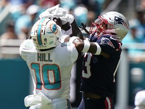 New England Patriots defensive back Jack Jones (13) tries to break up a pass to Miami Dolphins’ Tyreek Hill Sunday, Sept. 11, 2022, in Miami Gardens, Fla.