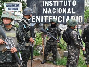 Honduran soldiers guard the facilities of the Women's Center for Social Adaptation (CEFAS) prison after a fire following a brawl between inmates in Tamara, some 25kms from Tegucigalpa, Honduras on June 20, 2023.