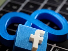 FILE: A 3D printed Facebook's new rebrand logo Meta and Facebook logo are placed on laptop keyboard in this illustration taken on November 2, 2021.
