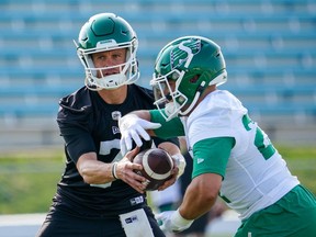 Saskatchewan Roughriders quarterback Trevor Harris, left, hands off the football to running back Kienan LaFrance, right, during the first day of spring training main camp in Saskatoon, Sask., on Sunday, May 14, 2023. The B.C. Lions say they have signed veteran running back Kienan LaFrance after he was released by the Saskatchewan Roughriders.