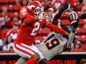 B.C. Lions wide receiver Dominique Rhymes, right, reaches for a pass as Calgary Stampeders defensive back Jonathan Moxey defends during second half CFL football action in Calgary, Thursday, June 8, 2023.
