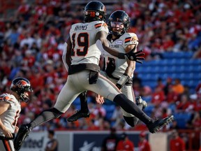 B.C. Lions wide receiver Dominique Rhymes, left, celebrates his touchdown with quarterback Vernon Adams during first half CFL football action against the Calgary Stampeders in Calgary, Thursday, June 8, 2023.
