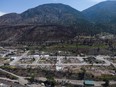 The remains of the village pool and debris covered properties that were destroyed by the 2021 wildfire are seen in Lytton, B.C., on Wednesday, June 15, 2022.