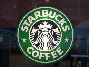 FILE - The Starbucks sign is displayed in the window of a Pittsburgh Starbucks, Jan. 30, 2023. On Monday, June 12, jurors in a federal court in New Jersey awarded $25.6 million to a former regional Starbucks manager who alleged that she and other white employees were unfairly punished by the coffee chain after the high-profile 2018 arrests of two Black men at one of the chain's Philadelphia locations.