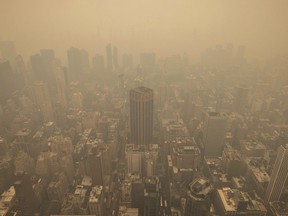 An aerial view shows New York City in a haze-filled sky from the Empire State Building observatory, Wednesday, June. 7, 2023, in New York. Smoke from Canadian wildfires poured into the U.S. East Coast and Midwest on Wednesday, covering cities of both nations in an unhealthy haze, holding up flights at major airports and prompting people to fish out pandemic-era face masks.