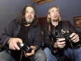 604 Records president Jonathan Simkin, left, and Nickelback singer/ guitarist Chad Kroeger play video games at 604 Records studios in Vancouver in 2004.