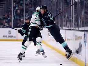 Carson Soucy of the Seattle Kraken checks Mason Marchment of the Dallas Stars during the first period in Game Three of the Second Round of the 2023 Stanley Cup Playoffs at Climate Pledge Arena on May 07, 2023 in Seattle, Washington.