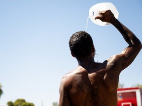 A person cools off amid searing heat that was forecast to reach 115 degrees Fahrenheit on July 16, 2023 in Phoenix, Arizona. A heat dome over Texas that has expanded to California, Nevada and Arizona is subjecting millions of Americans to excessive heat warnings, according to the National Weather Service.