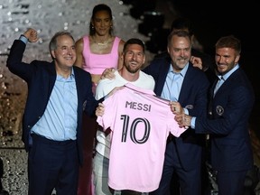 Managing Owner Jorge Mas, Lionel Messi, Co-Owner Jose Mas, and Co-Owner David Beckham pose during "The Unveil" introducing Lionel Messi hosted by Inter Miami CF at DRV PNK Stadium on July 16, 2023 in Fort Lauderdale, Florida.