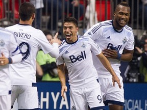 Nicolas Mezquida #9 of the Vancouver Whitecaps FC celebrates with Octavio Rivero #29 and Kendall Waston #4 after scoring a goal against the Portland Timbers in MLS action on March, 28, 2015 at B.C. Place Stadium.