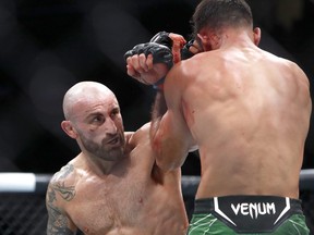 UFC featherweight champion Alexander Volkanovski (left) battles with interim featherweight champion Yair Rodriguez during UFC 290 at T-Mobile Arena on July 8, 2023 in Las Vegas, Nevada.