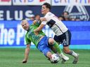 Seattle Sounders' Albert Rusnak, left, and Vancouver Whitecaps' Sebastian Berhalter vie for the ball during MLS action in Vancouver, on May 20.