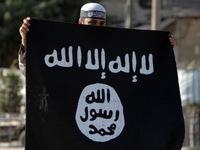 A Palestinian Salafist holds an Al-Qaeda-affiliated flag during a protest in the southern Gaza Strip on September 14, 2012.