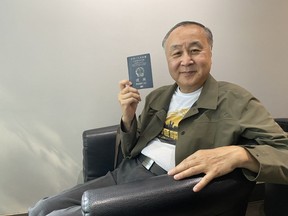 Hong Kong democracy activist Elmer Yuen shows his Hong Kong passport during an interview in Vancouver on Wednesday, July 5, 2023. The Hong Kong government has offered a $170,000 reward for Yuen's arrest, accusing him of national security offences.THE CANADIAN PRESS/Nono Shen