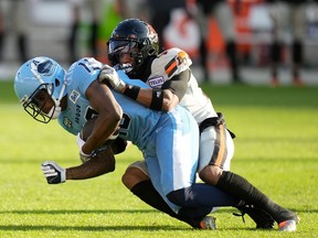 B.C. Lions defensive back Marcus Sayles (14) tackles Toronto Argonauts wide receiver Kurleigh Gittens Jr. (19) during first half CFL action in Toronto on Monday, July 3, 2023.