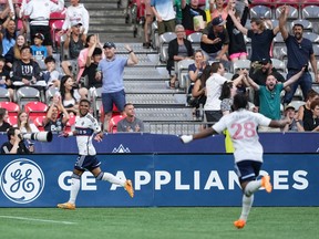 Vancouver Whitecaps' Pedro Vite, back left, and Levonte Johnson celebrate Vite's goal against Austin FC during the first half of an MLS soccer match in Vancouver, on Wednesday, July 12, 2023.