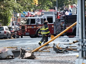 Debris from a crane collapse sits on the road as police, firefighters and emergency personnel gather at the scene in midtown Manhattan on July 26, 2023 in New York.