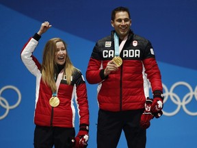 Curling mixed doubles gold medallists Kaitlyn Lawes, left, and John Morris, of Canada, celebrate during the medals ceremony at the 2018 Winter Olympics in Pyeongchang, South Korea, Wednesday, Feb. 14, 2018. Canadian curlers will be able to compete in both mixed doubles and four-player teams at the 2026 Winter Olympics.