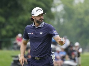 Adam Hadwin acknowledges the crowd after his par putt to tie Collin Morikawa and Rickie Fowler for a playoff during the final round of the Rocket Mortgage Classic golf tournament at Detroit Country Club, Sunday, July 2, 2023, in Detroit. Hadwin tied for second at the Classic, losing to eventual champion Fowler.