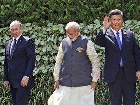 FILE- Russian President Vladimir Putin, Indian Prime Minister Narendra Modi, and Chinese President Xi Jinping stand at the start of the BRICS Summit in Goa, India, Sunday, Oct. 16, 2016. Modi on Tuesday, July 4, 2023, took a veiled swipe at rival neighbor Pakistan and avoided mentioning the war in Ukraine while addressing a group of Asian countries led by China and Russia. In his opening speech to the Shanghai Cooperation Organization, he said the group should not hesitate to criticize countries that are "using terrorism as an instrument of its state policy."