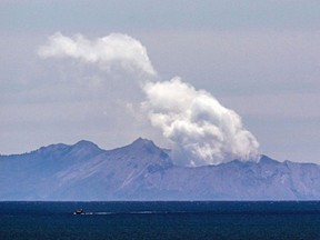 FILE: Steam rises from the White Island volcano two days after a volcanic eruption off the coast of Whakatane on December 11, 2019.