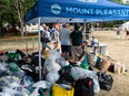 Volunteers help sort through clothes donated by people for those displaced by Thursday's apartment fire on E. 10th Ave., at Dude Chilling Park in Vancouver, BC Saturday, July 29, 2023. Photo by Jason Payne/PNG.