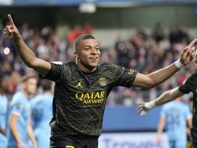 FILE - PSG's Kylian Mbappe celebrates after scoring his side's opening goal during the French League One soccer match between Troyes and Paris Saint Germain, at the Stade de l'Aube, in Troyes, France, Sunday, May 7, 2023. Saudi Arabian soccer team Al-Hilal has made a record $332 million bid for France striker Kylian Mbappe. Paris Saint-Germain has confirmed the offer and says it has given Al-Hilal permission to open negotiations directly with Mbappe.