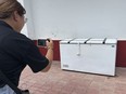 A Thai reporter takes a photo of an empty freezer at the Nong Prue police station in Pattaya, Chonburi province, Thailand, Tuesday, July 11, 2023.