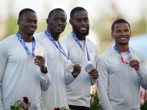 From left: Aaron Brown, Jerome Blake, Brendon Rodney and Andre De Grasse pose with their Tokyo Olympics silver medals after being awarded the upgraded medals during a ceremony at the Canadian track and field championships.