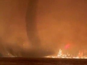 A fire tornado, or fire whirl, is seen in a video shot by the BC Wildfire Service at Gun Lake in the B.C. Interior overnight on August 17, 2023.