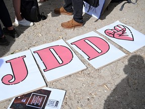 Signs to read out JDD are seen on the ground during a demonstration of striking journalists of weekly daily Le Journal du Dimanche (JDD) against the nomination of Geoffroy Lejeune as the newspaper's new managing editor, in Paris, on July 19, 2023.