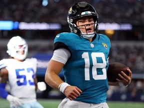 Nathan Rourke #18 of the Jacksonville Jaguars carries the ball on a touchdown run against the Dallas Cowboys in a preseason game at AT&T Stadium on August 12, 2023 in Arlington, Texas.